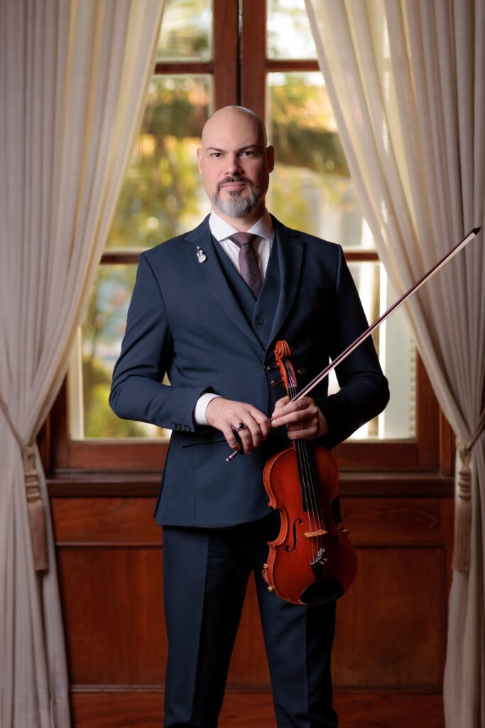Ivan Fritzen holding a violin in a formal portrait